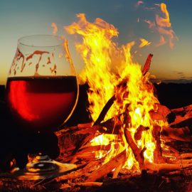 Belgian Dark Ale being enjoyed in the cooler months of winter by a campfire