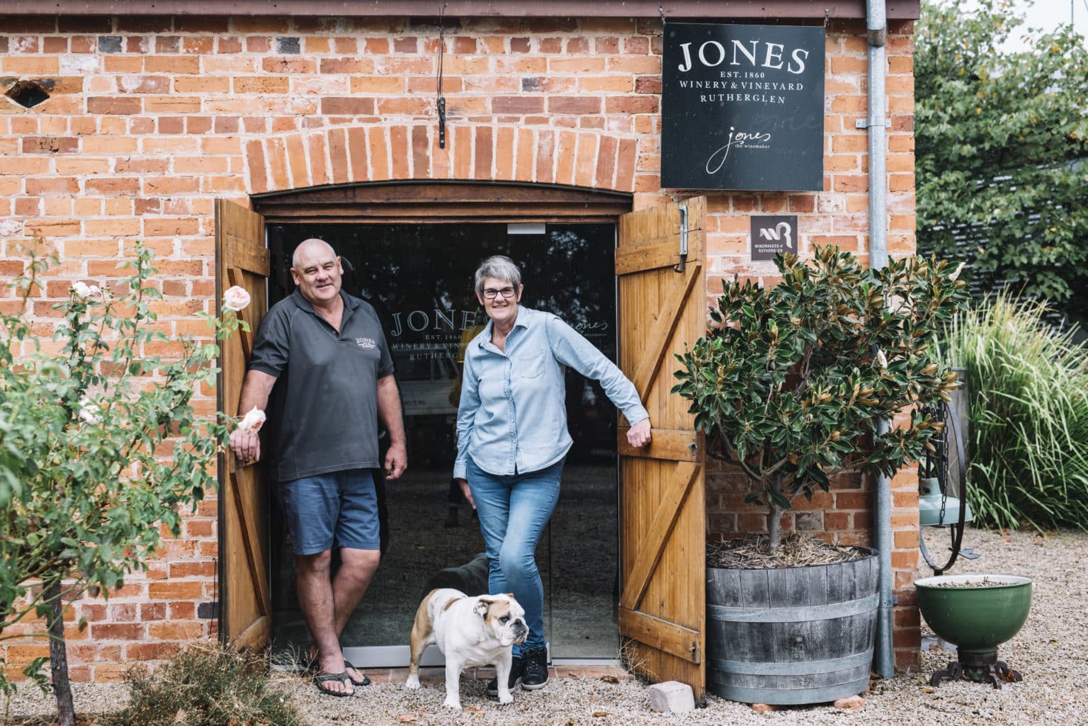 Mandy and Arthur Jones with their bulldog at the cellar door, Jones WInery.