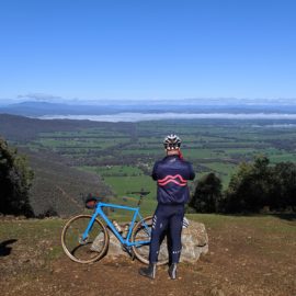 A gravel cyclists taking a photo at a lookout near Beechworth