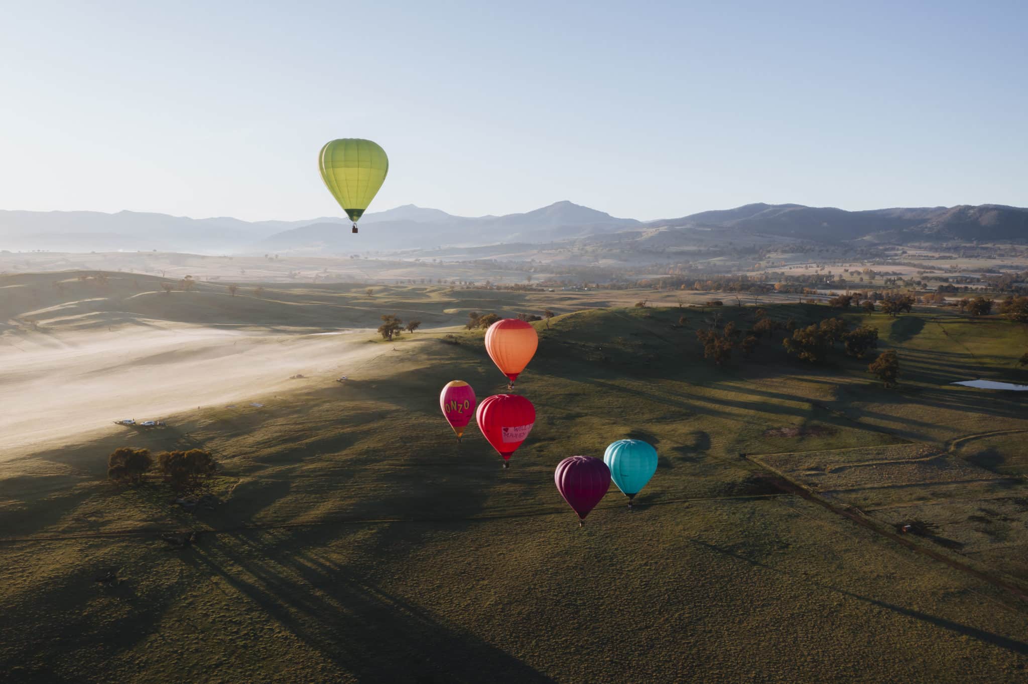 An aerial shot of hot air balloons flying over Mansfield in the morning mist.