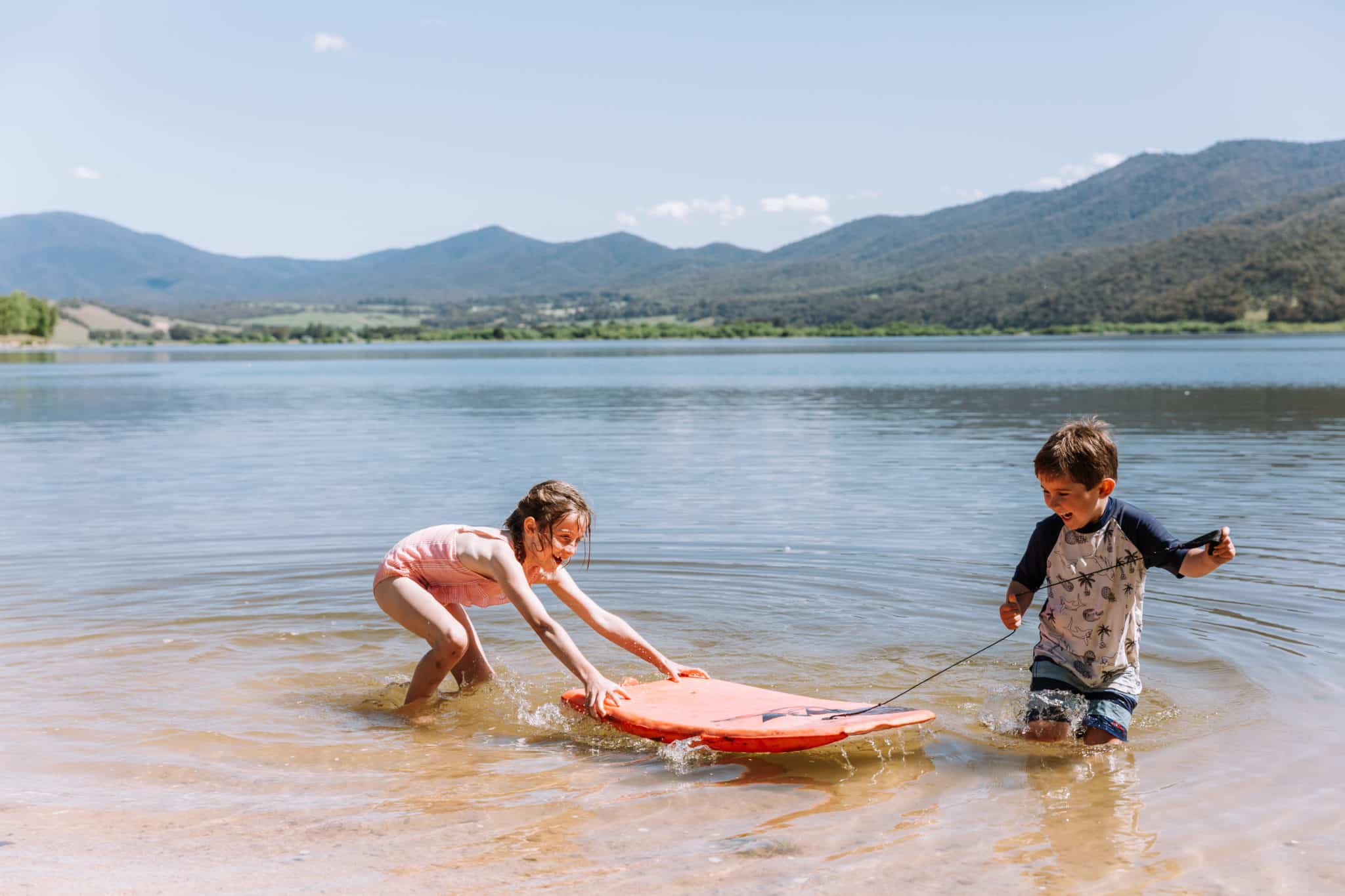 Two children paddle boarding at Lake Hume, summer