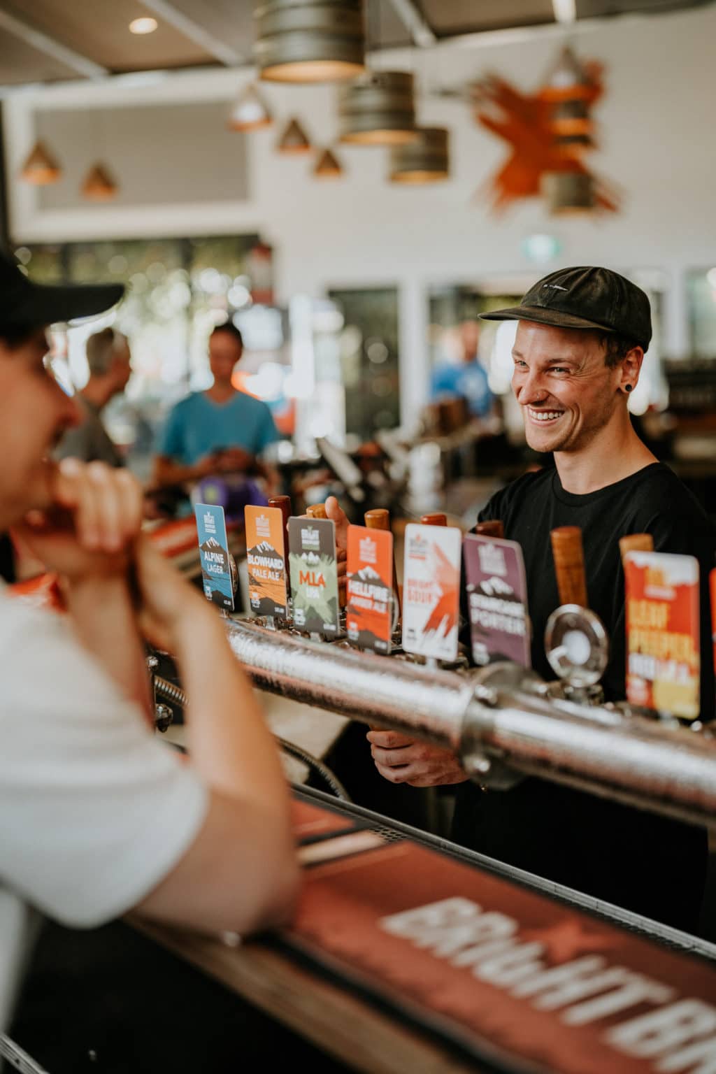 Male bartender smiling at a customer, Bright Brewery.