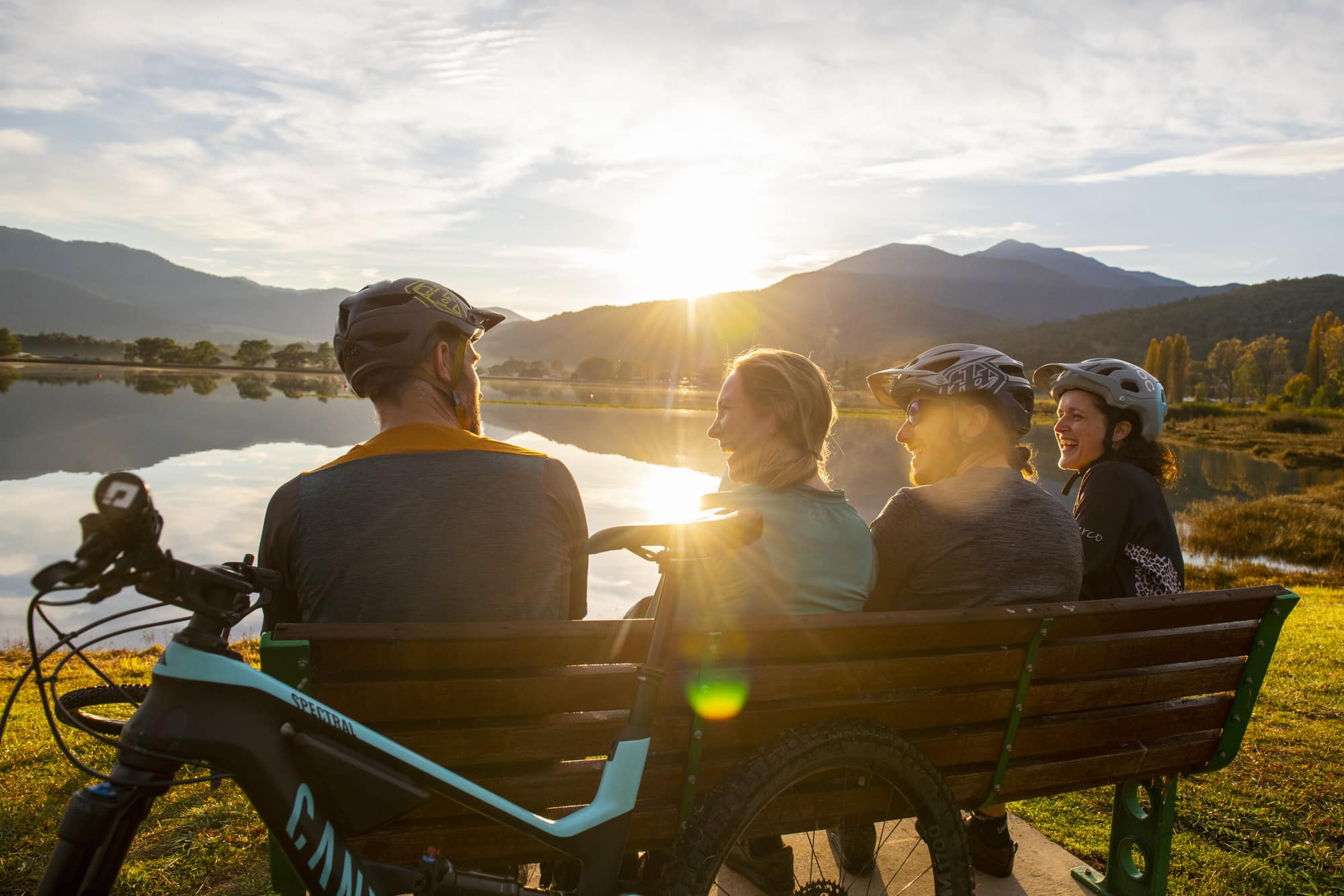 Group of cyclists relaxing at the Mount Beauty Pondage at sunset