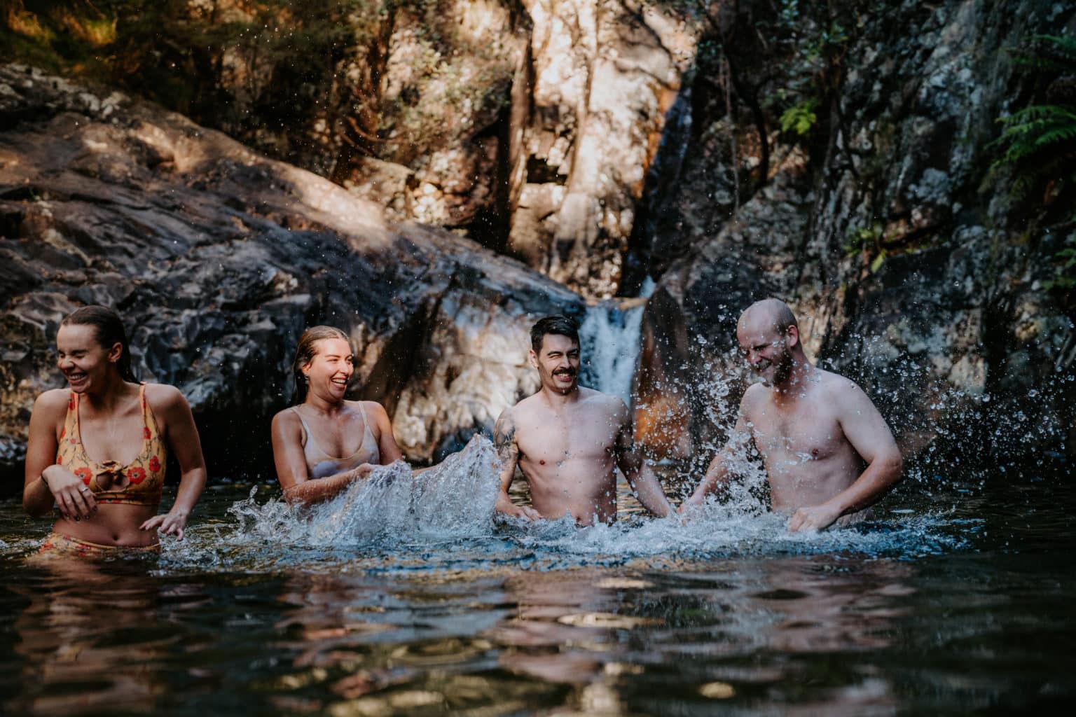Four friends swimming at Rollasons Falls