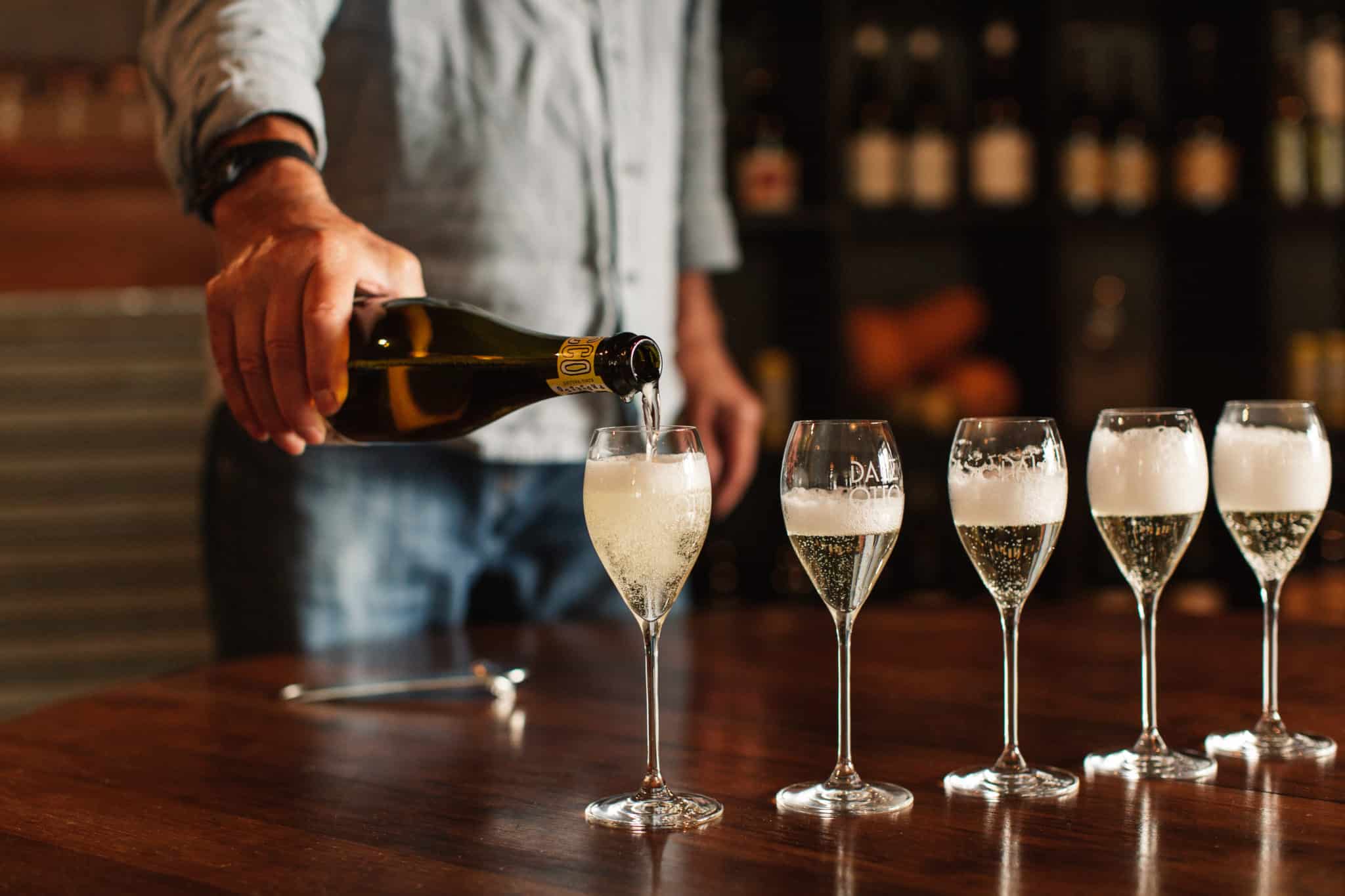 Pouring prosecco at Dal Zotto Cellar Door