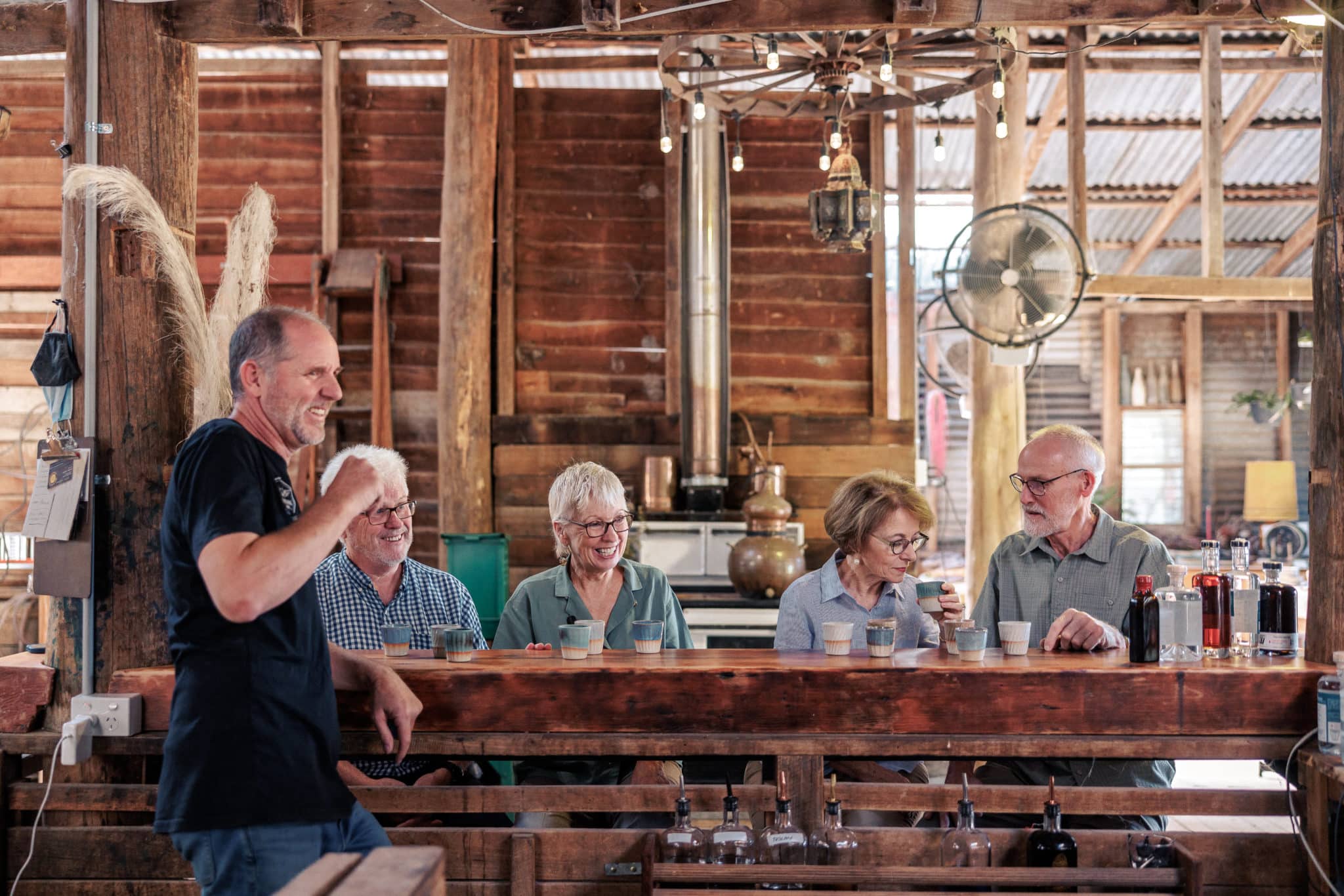 FOUR PEOPLE PARTICIPATING IN A GIN TASTING AT BARKING OWL DISTILLING CO
