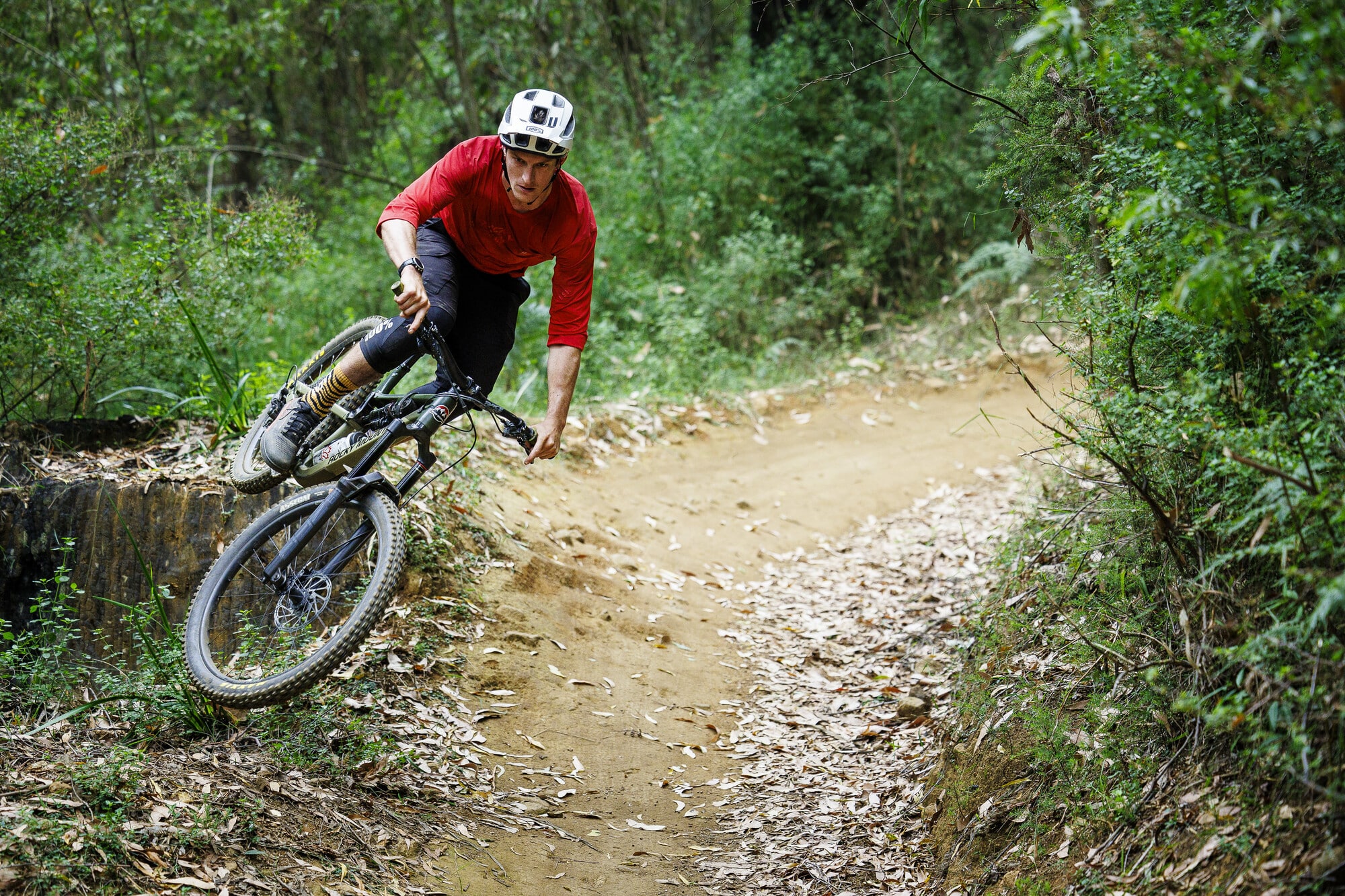 Cyclist riding berms at Lake Mountain Bike Park