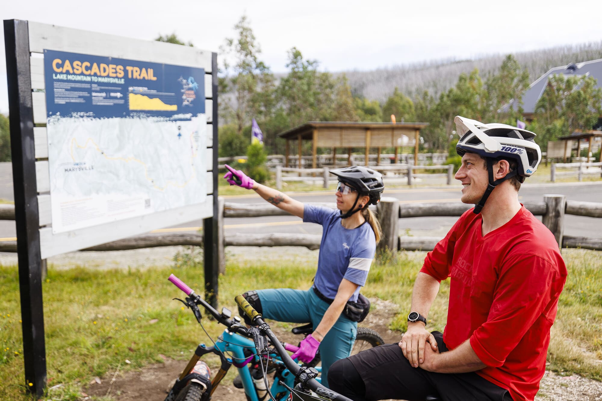 Two cyclists planning their ride on the Cascades Trail
