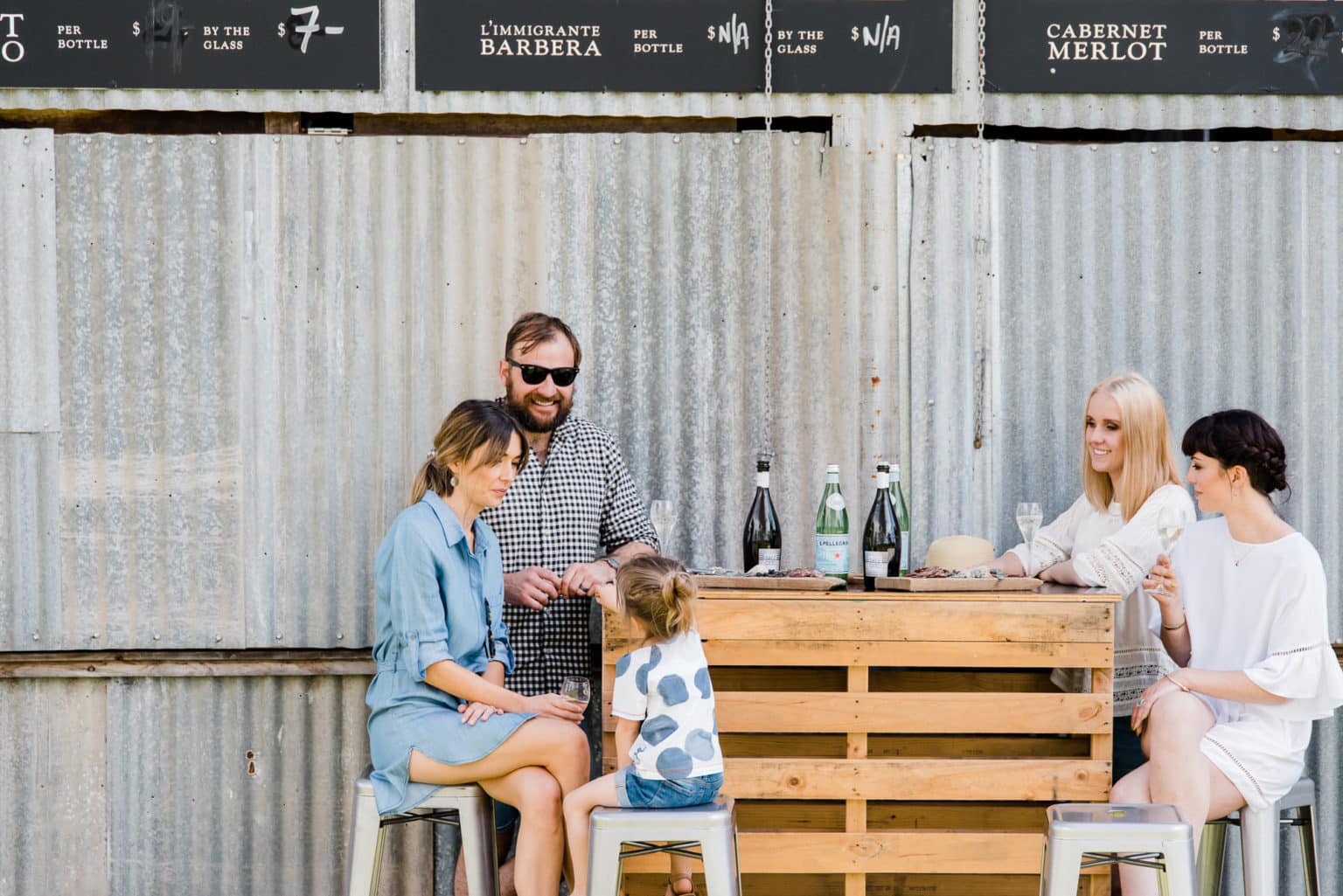 A family sitting outside at Dal Zotto Wines.