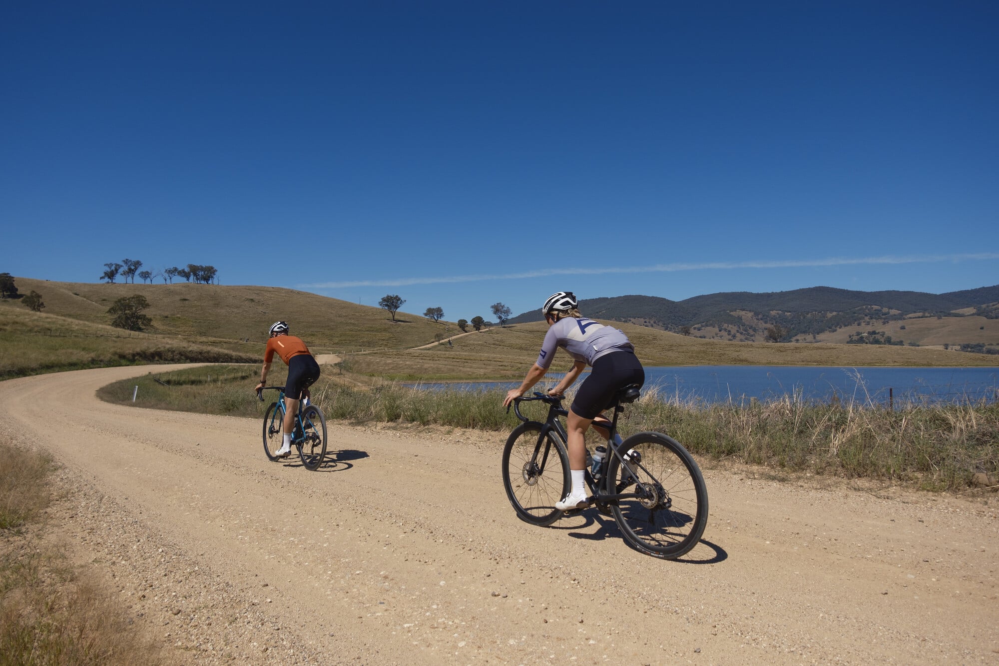 Two gravel cyclists riding on gravel next to Lake Hume in the Upper Murray near Bethanga and Tallangatta.