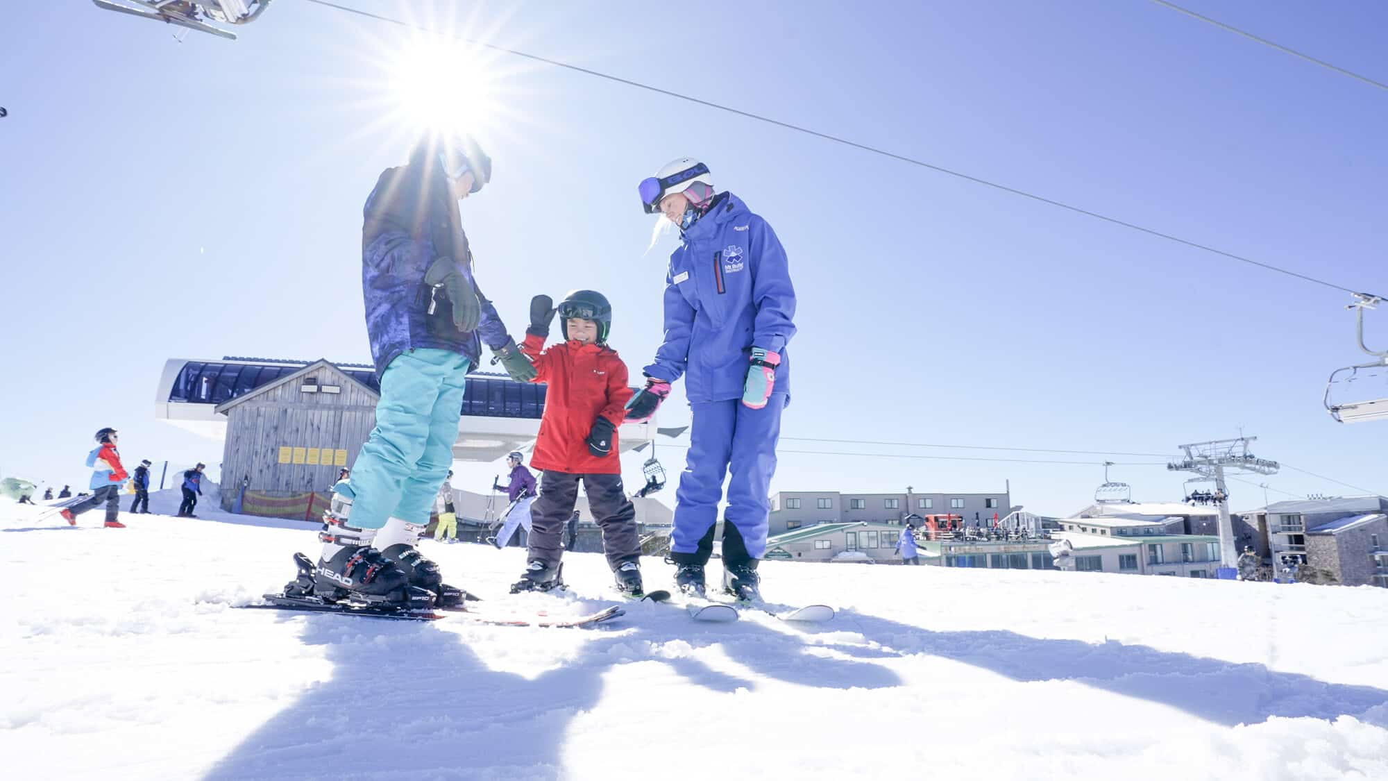 A dad and child in a ski lesson at Mt Buller