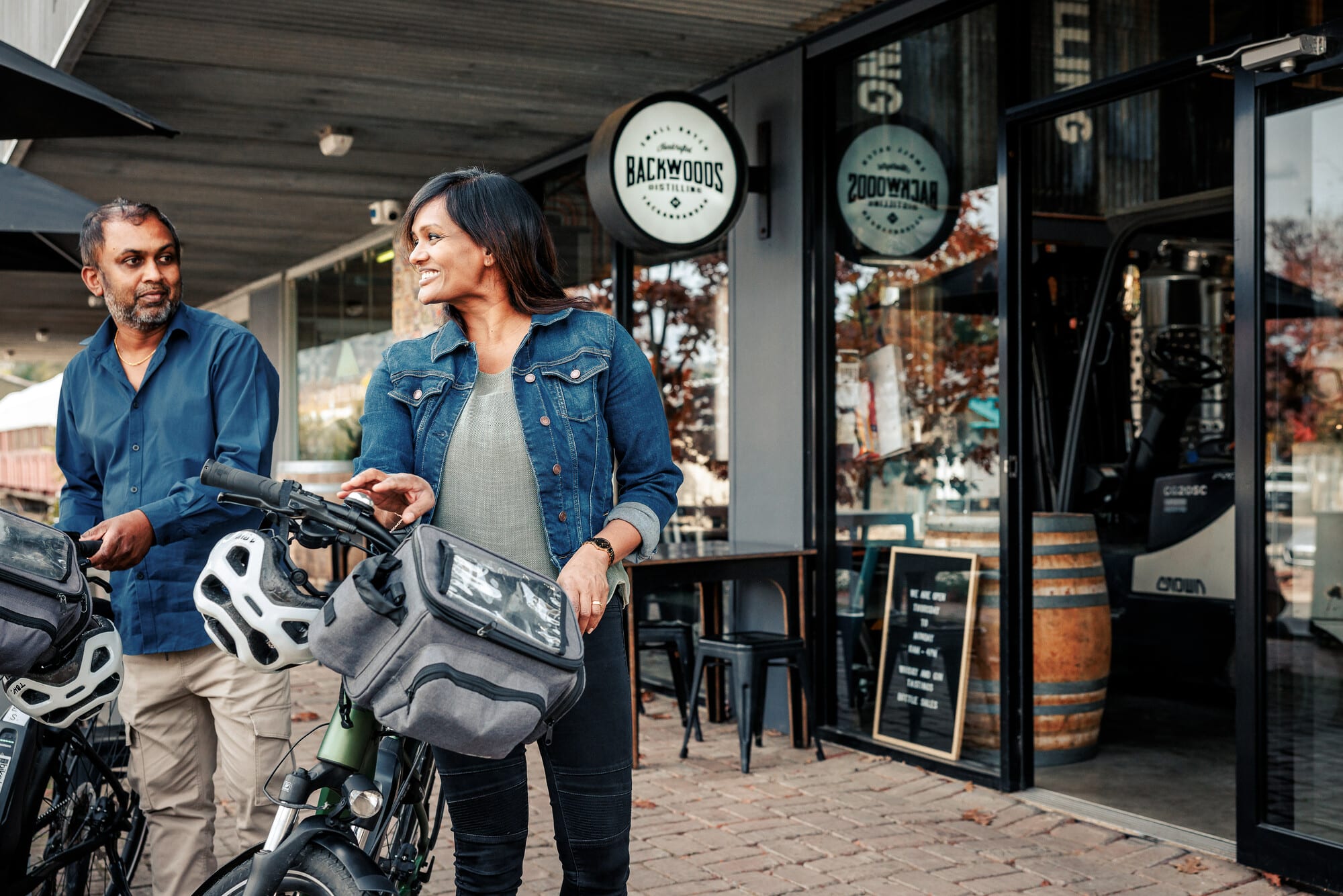 Two cyclists stopping at Backwoods Distillery on the Murray to Mountains Rail Trail