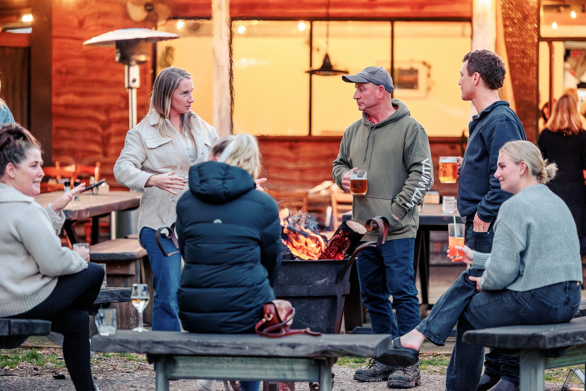 A group of friends enjoying drinks at the outdoor fire pit at Mitta Mitta Brewing Co