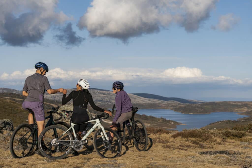 Group of gravel riders looking out at views over Rocky Valley Lake in Falls Creek.