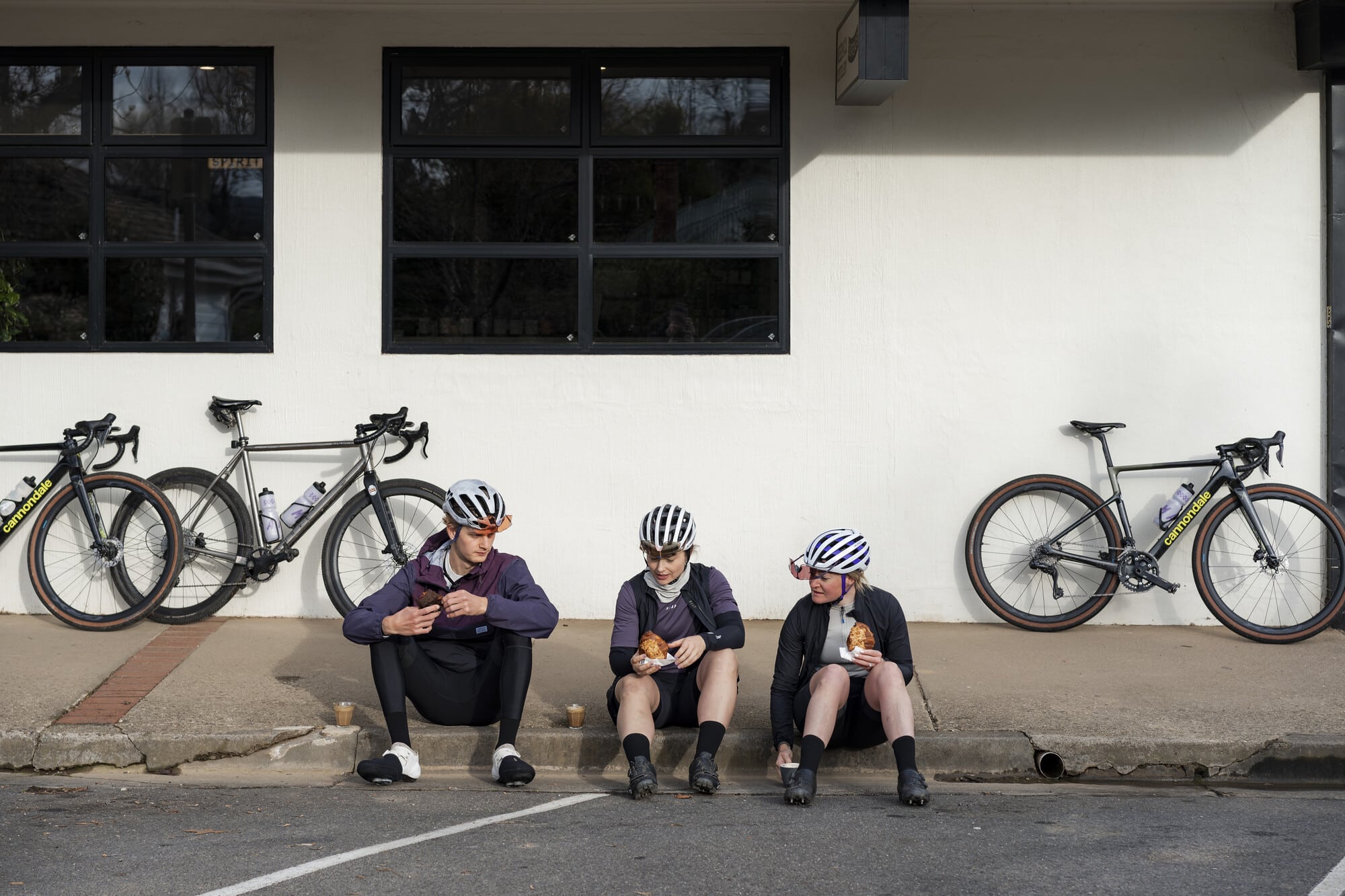 Three riders enjoying sixpence coffee and pastries after a ride on the Ride High Country Gravel Network.
