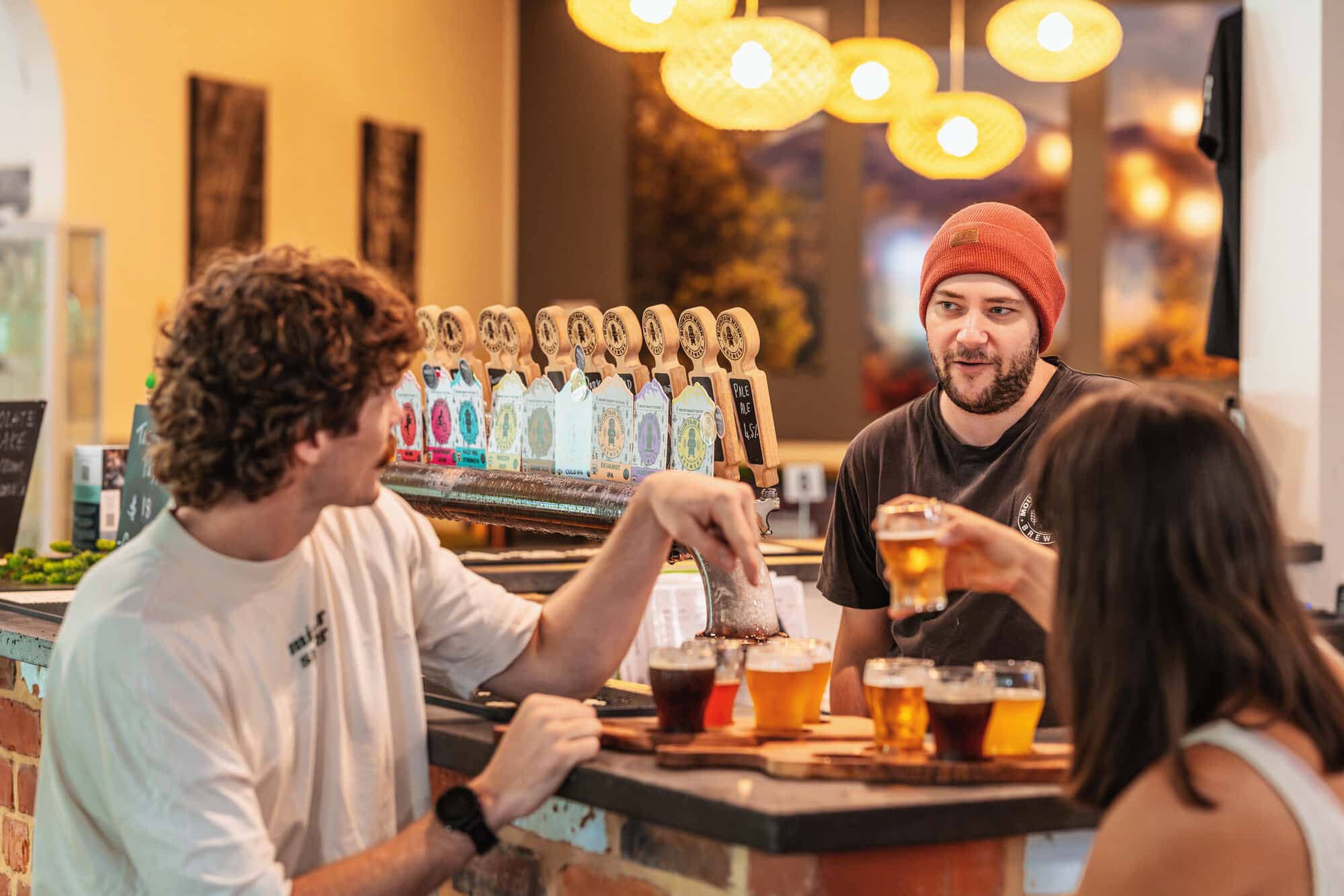 Two people enjoying drinks at Mountain Monk Brewers in Mount Beauty.