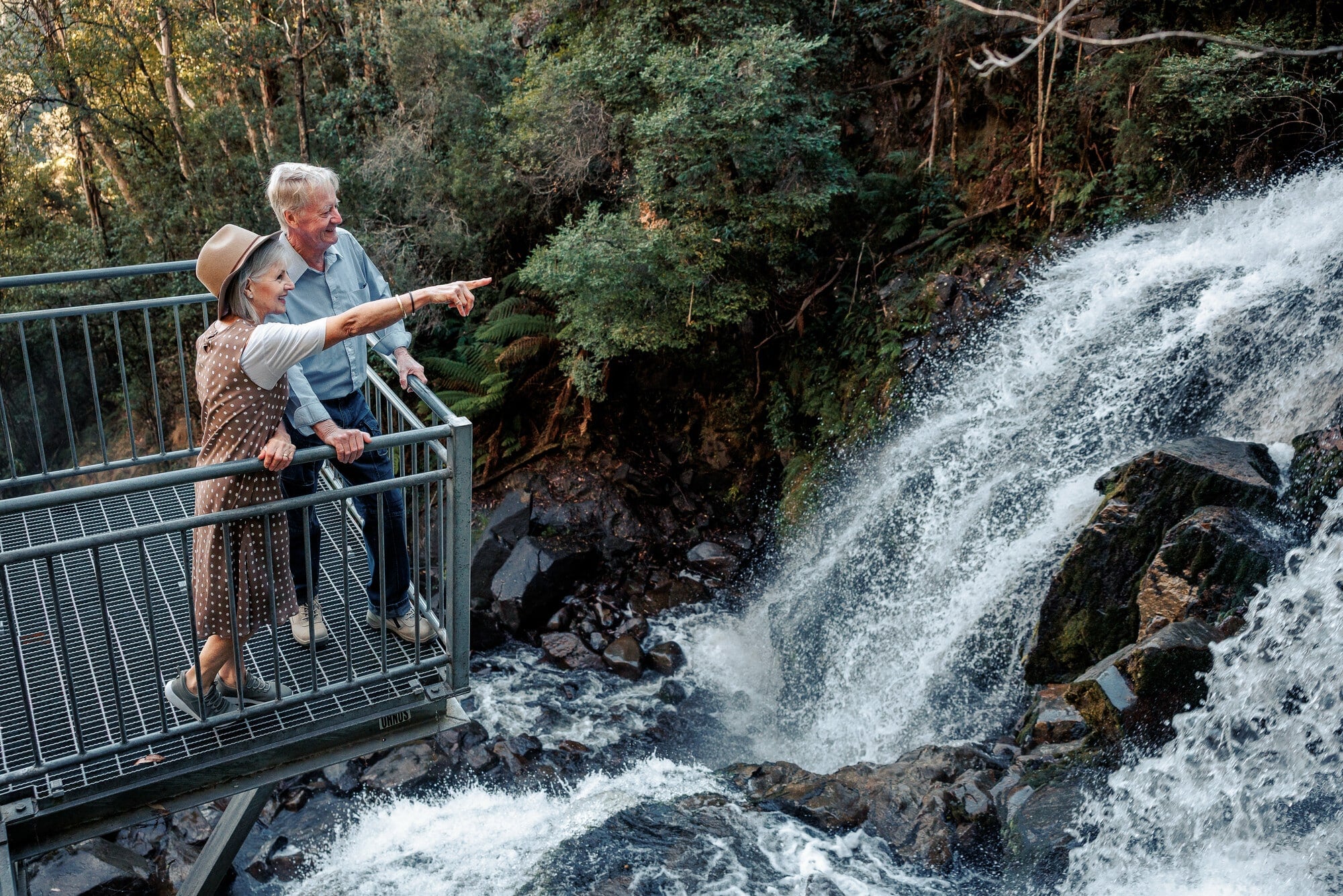 Two people marvelling at Snobs Creek Falls from the lookout platform.