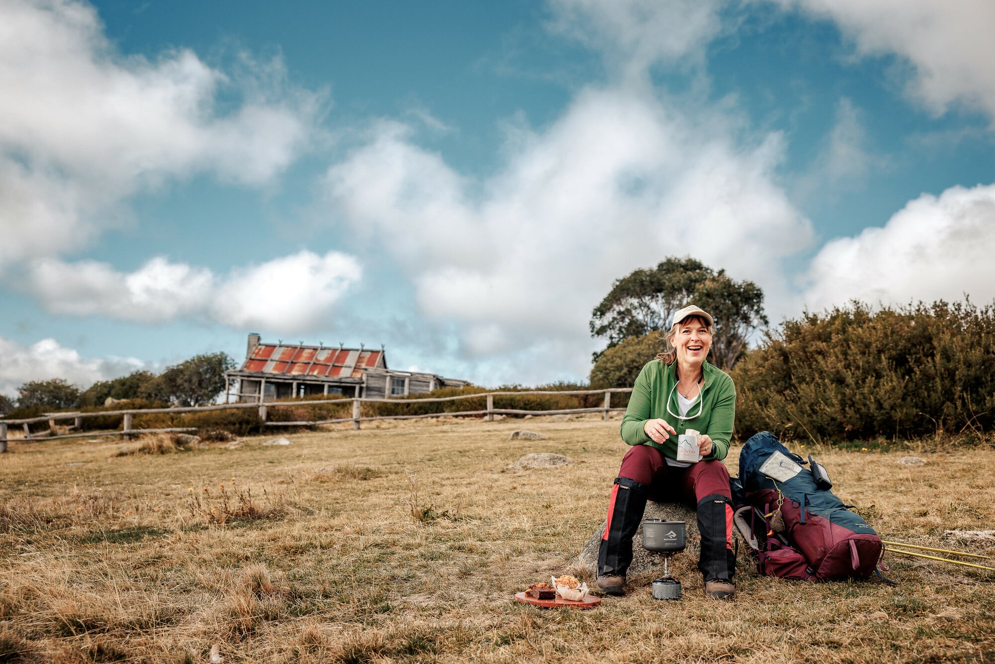 Person enjoying coffee and snacks at Craig's Hut on stop of Mt Stirling