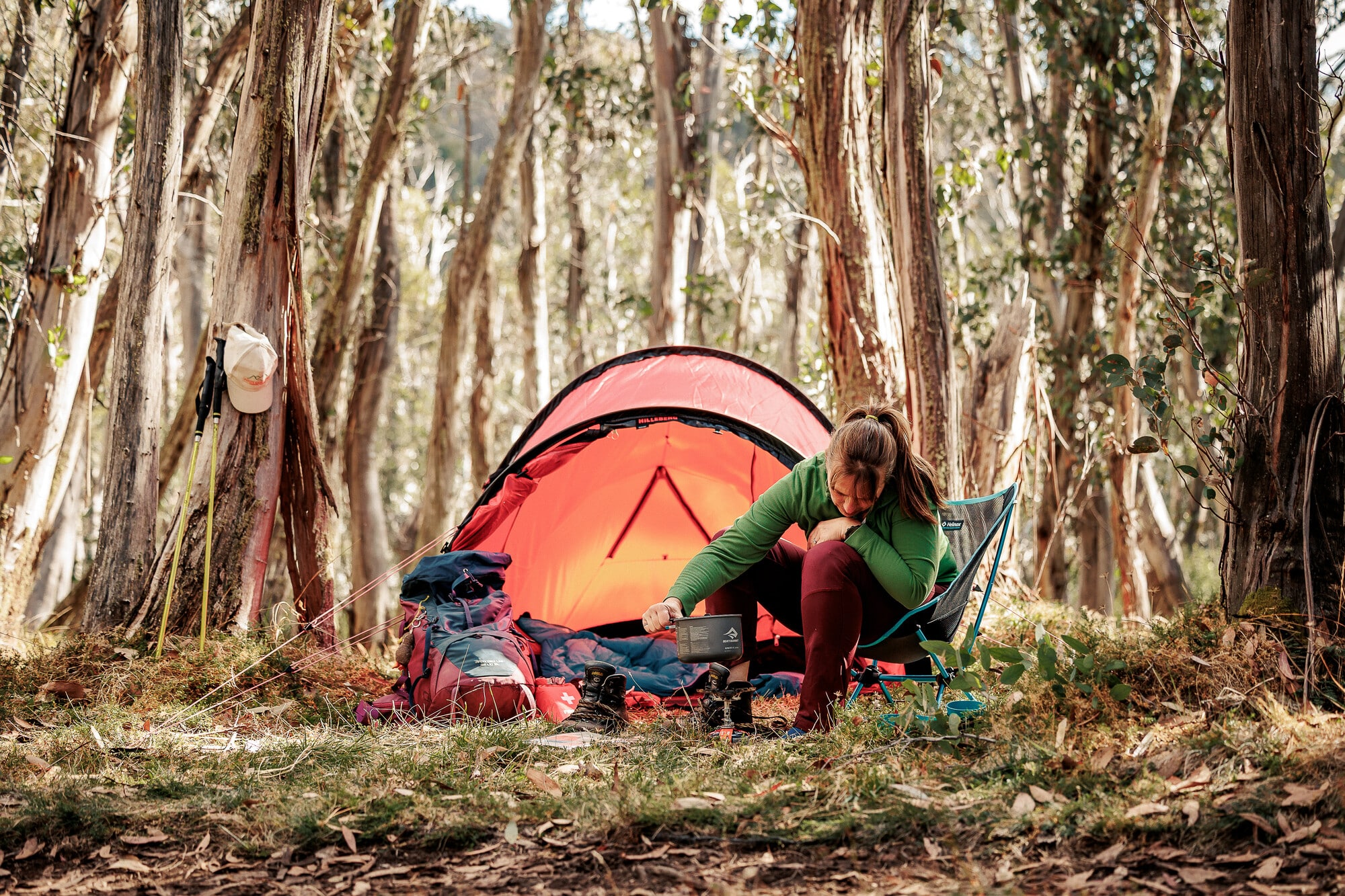 Person camping on Mt Stirling with native forest in the background