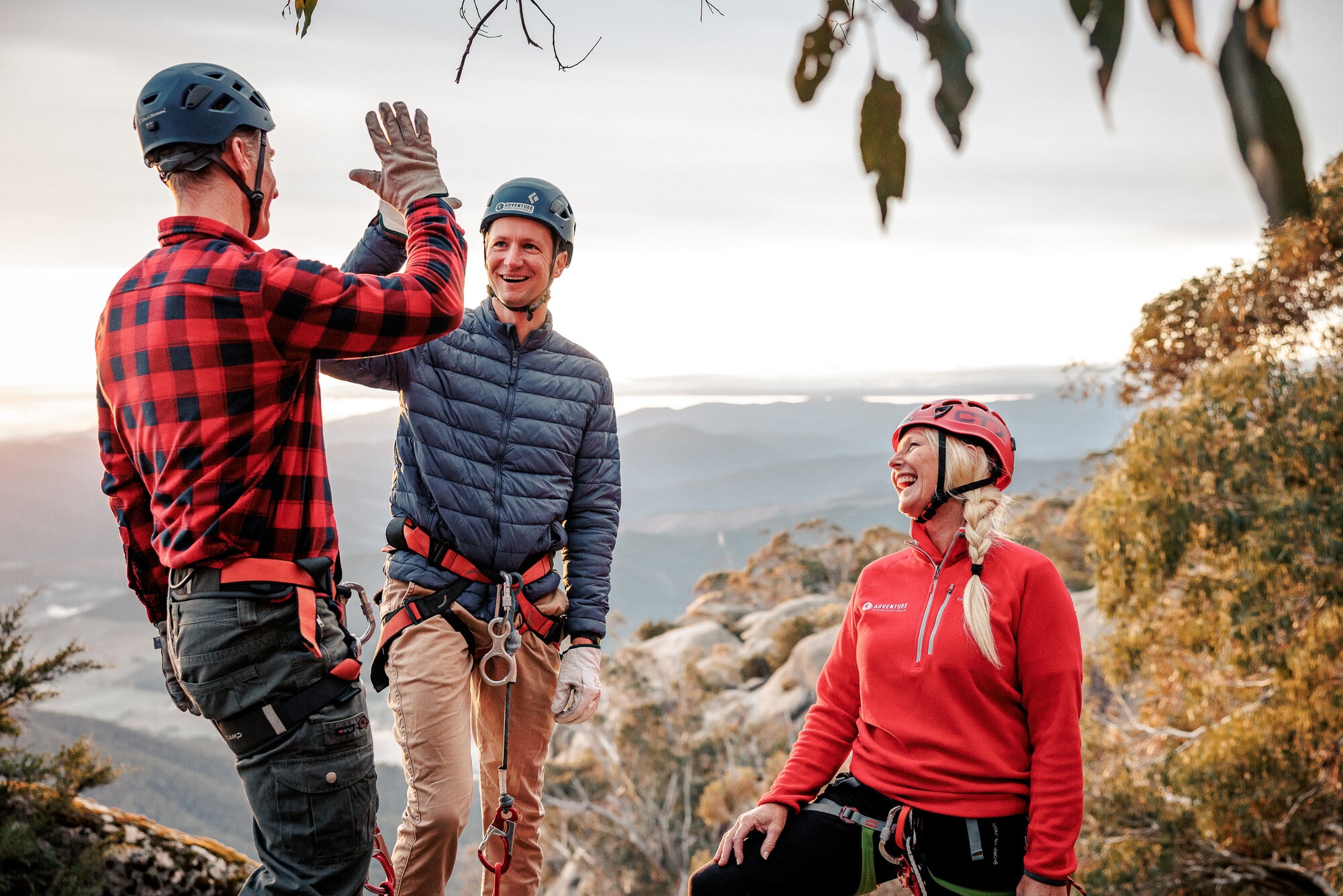 Group preparing to climb and abseil Mount Buffalo's cliffs with Adventure Guides Australia with mountain views in the background