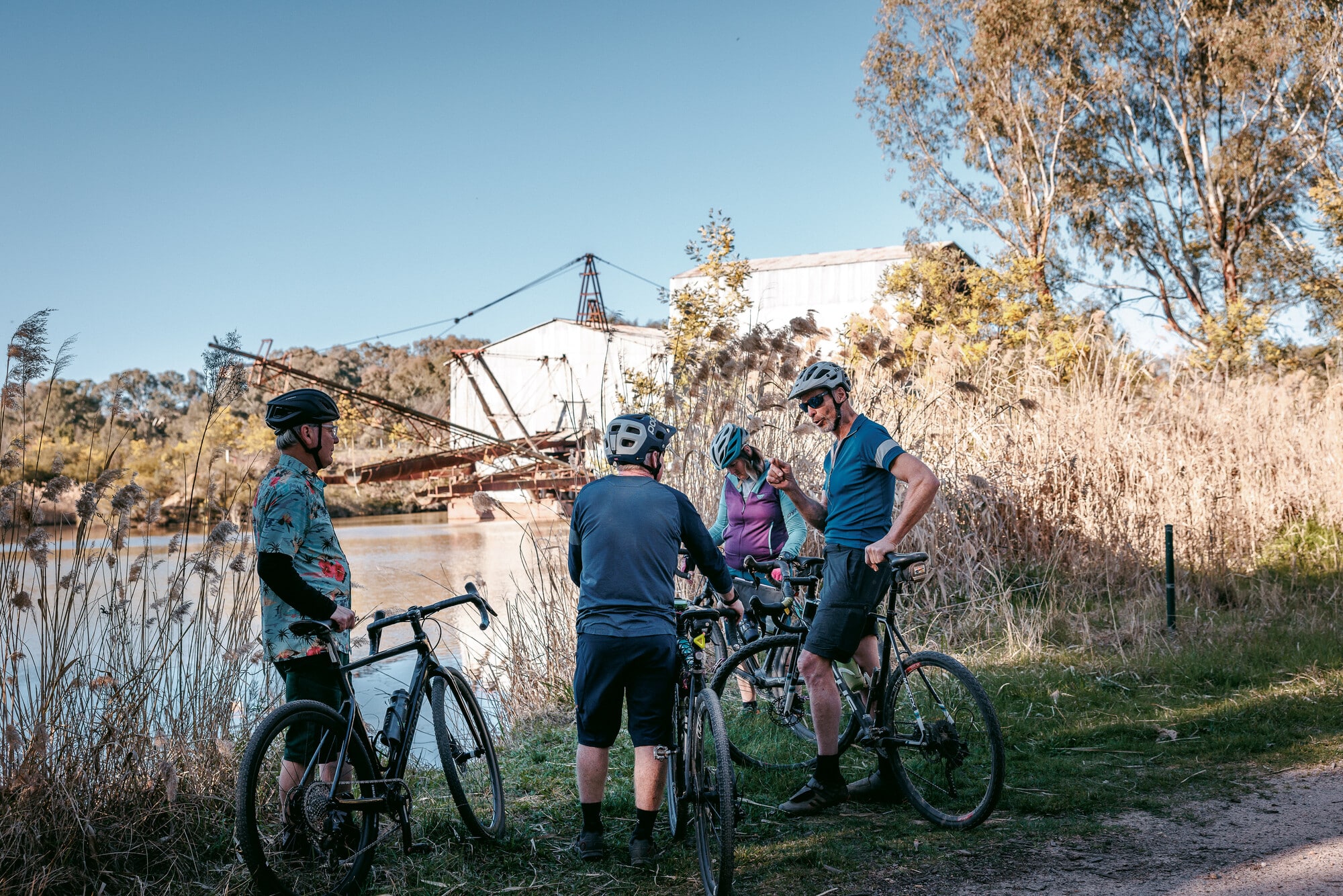 Group of cyclists at the historic Eldorado Dredge on the Wangaratta - Eldorado Loop gravel route.