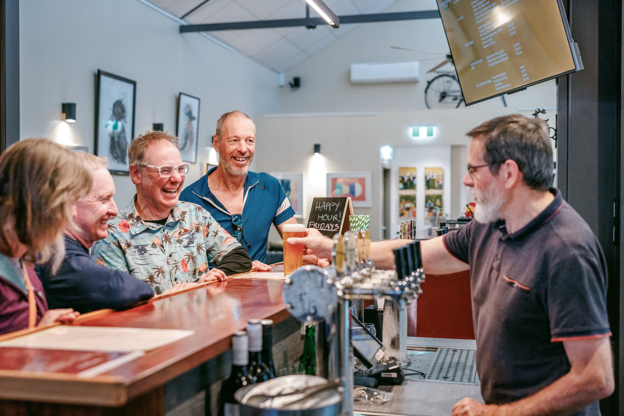 Group of cyclists celebrating their ride on Wangaratta's gravel at the Pedal Slowly Brewhouse.