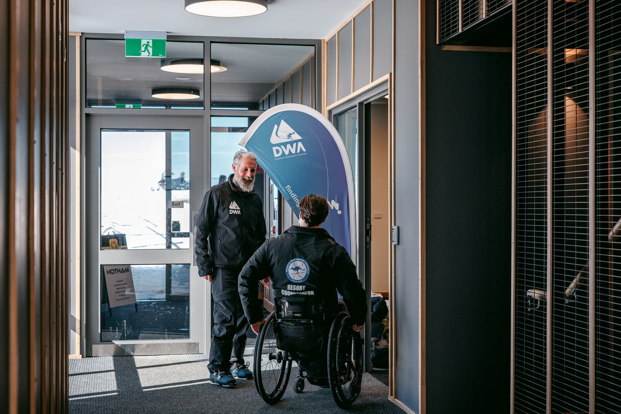 Adaptive visitor in the Alpine Gateway Visitor Facility checking into their guided Disabled Wintersport Australia session.