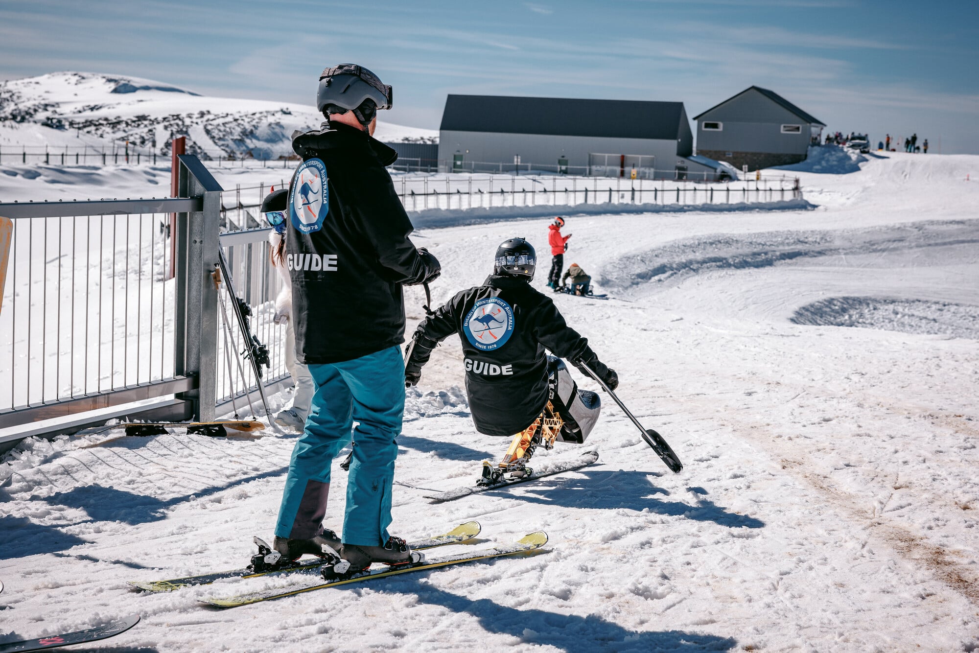 Adaptive skier and Disabled Wintersport Australia guides accessing the snow straight from the Disabled Wintersport Australia lounge at Mt Hotham.