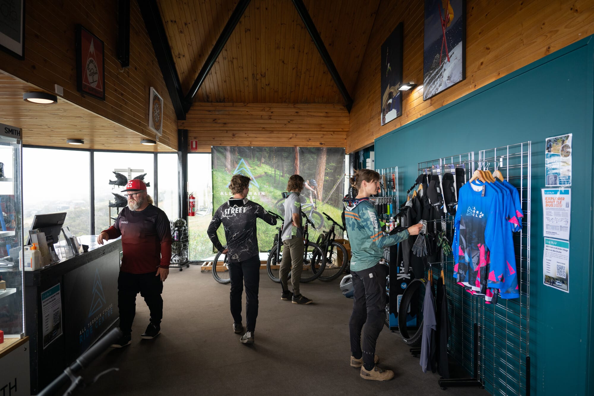 Group of cyclists browsing mountain bike gear at All Terrain Cycles on-mountain Mt Buller store.