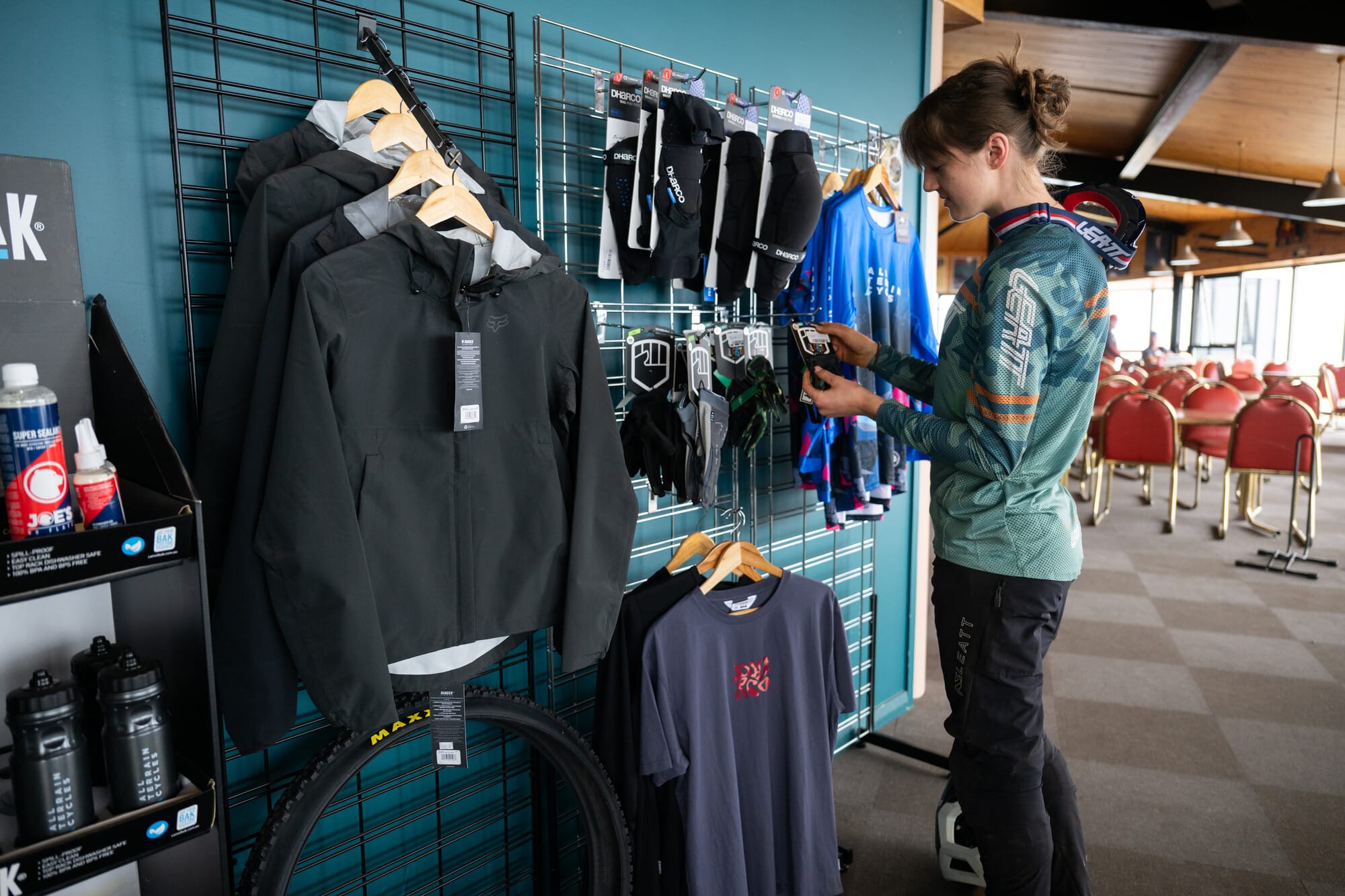 Cyclist browsing mountain bike gear at All Terrain Cycles on-mountain Mt Buller store.