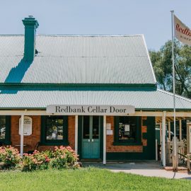 Old brick building with green tin roof - Milawa Providore