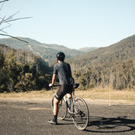 A road cyclist looks up to Falls Creek